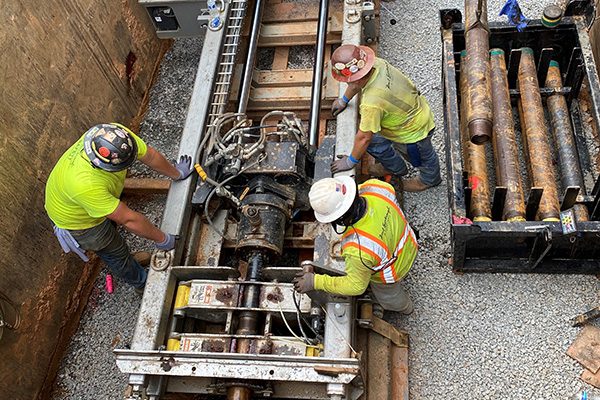 men operating boring drill